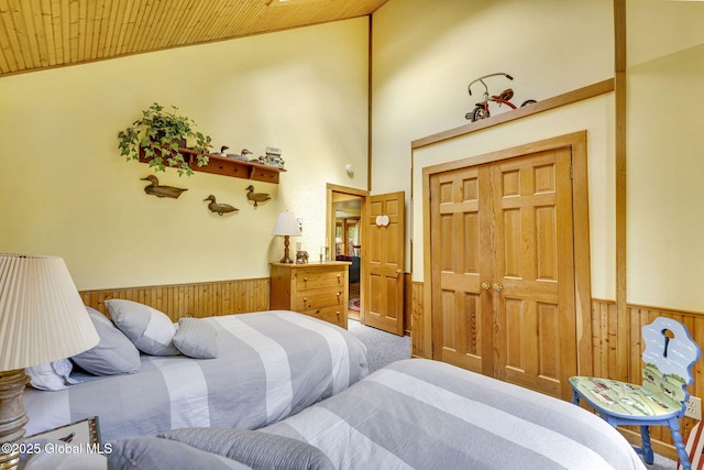 2555 County Highway 22, Exeter, NY 13315 - bedroom featuring carpet floors, wainscoting, wooden ceiling, wood walls, and a closet