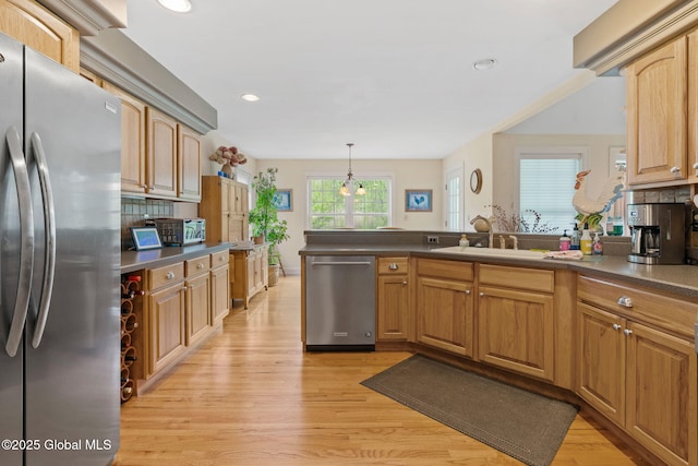 6 Rose Ct, Malta, NY 12019 - kitchen with appliances with stainless steel finishes, light wood-style floors, decorative backsplash, a peninsula, and recessed lighting
