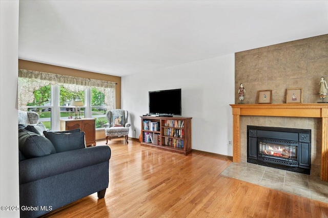 15 Iris Ave, Moreau, NY 12803 - living room featuring a tiled fireplace, wood finished floors, and baseboards