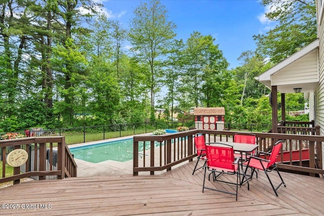 15 Iris Ave, Moreau, NY 12803 - wooden deck with a fenced backyard, outdoor dining area, and view of wooded area
