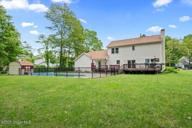 15 Iris Ave, Moreau, NY 12803 - back of property with a chimney, a wooden deck, and a patio