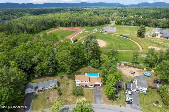 15 Iris Ave, Moreau, NY 12803 - aerial overview of property's location with a heavily wooded area and a mountainous background
