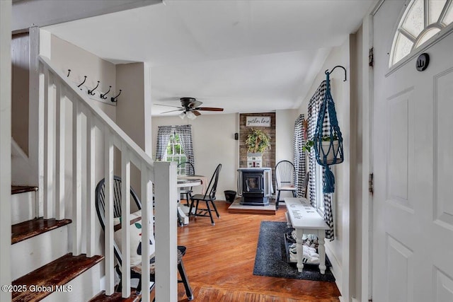 212 County Route 70, Stillwater, NY 12170 - foyer entrance with stairway, a wood stove, wood finished floors, and ceiling fan