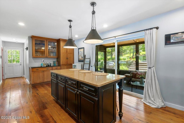 162 Methodist Farm Rd, Sand Lake, NY 12018 - kitchen featuring wood-type flooring, a center island, hanging light fixtures, glass insert cabinets, and recessed lighting