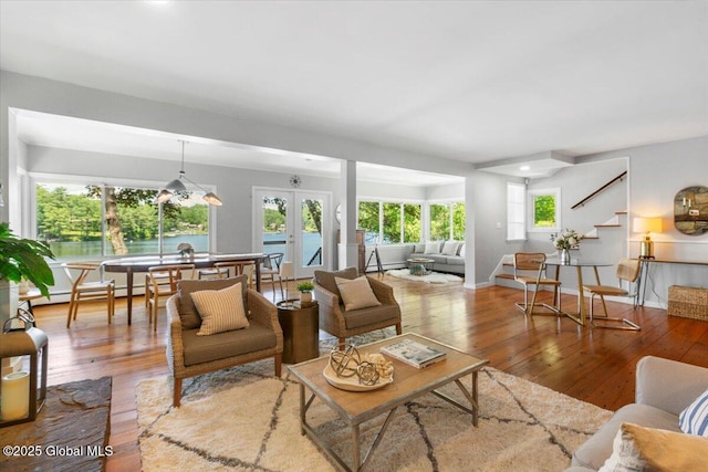 162 Methodist Farm Rd, Sand Lake, NY 12018 - living room with stairway, wood-type flooring, french doors, and a baseboard heating unit