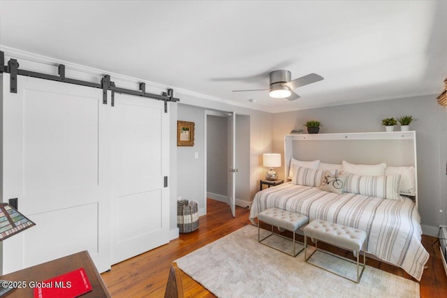 162 Methodist Farm Rd, Sand Lake, NY 12018 - bedroom with a barn door, wood finished floors, a ceiling fan, and ornamental molding
