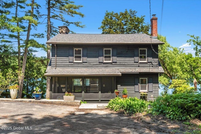 162 Methodist Farm Rd, Sand Lake, NY 12018 - view of front of house with a sunroom, a chimney, and roof with shingles