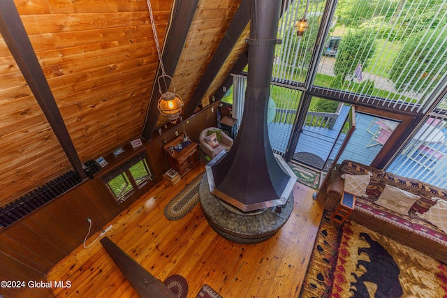 17 Oak Cir, Day, NY 12835 - living area featuring hardwood / wood-style floors, a wood stove, and a wood ceiling with exposed beams