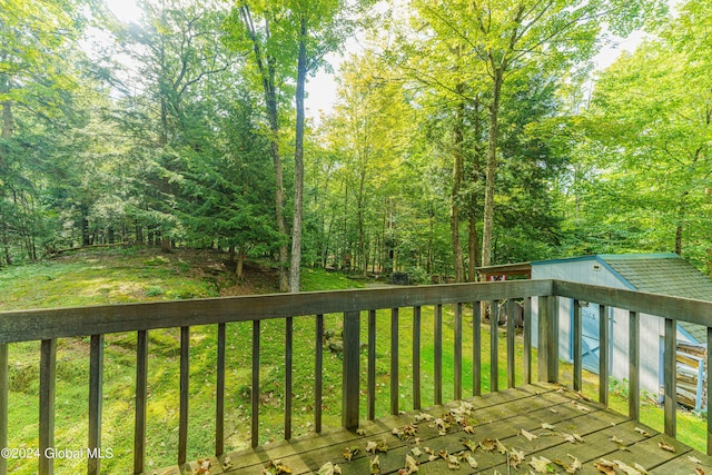 17 Oak Cir, Day, NY 12835 - wooden deck featuring a lawn, a storage shed, and a forest view