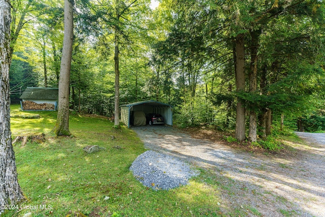 17 Oak Cir, Day, NY 12835 - view of grassy yard featuring a carport, driveway, and a wooded view