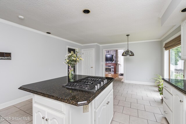 987 Grooms Rd, Rexford, NY 12148 - kitchen featuring stainless steel gas stovetop, baseboards, light tile patterned floors, white cabinets, and a textured ceiling