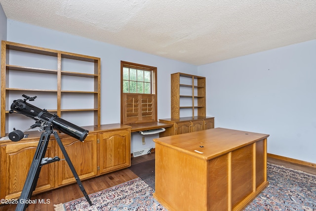 987 Grooms Rd, Rexford, NY 12148 - office area featuring dark wood-style flooring, a textured ceiling, built in study area, and baseboards