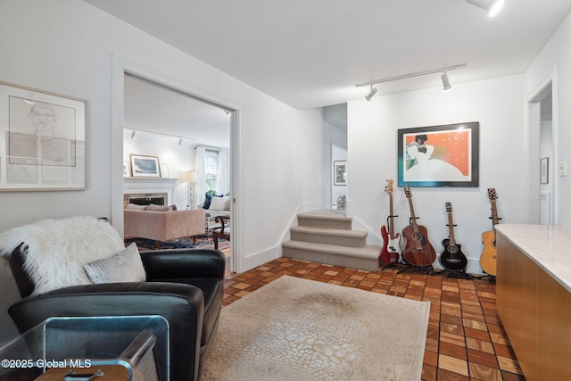 20 Darroch Rd, Bethlehem, NY 12054 - living room with rail lighting, stairs, and a fireplace