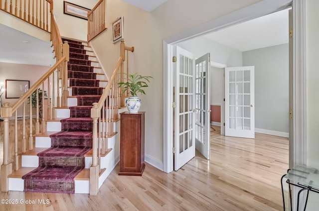 9 Oakline Ct, Niskayuna, NY 12309 - staircase with wood finished floors, baseboards, and french doors