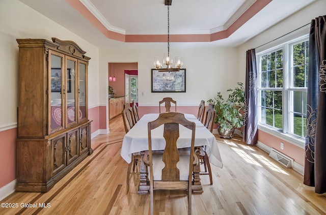 9 Oakline Ct, Niskayuna, NY 12309 - dining space featuring a raised ceiling, a chandelier, light wood-type flooring, baseboards, and ornamental molding