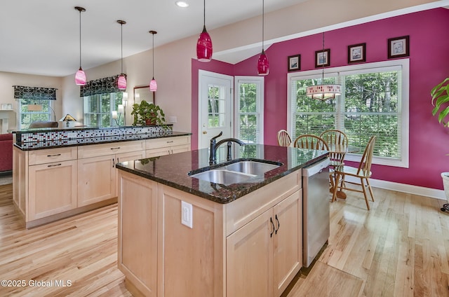 9 Oakline Ct, Niskayuna, NY 12309 - kitchen with stainless steel dishwasher, a sink, light brown cabinets, an island with sink, and light wood-style floors