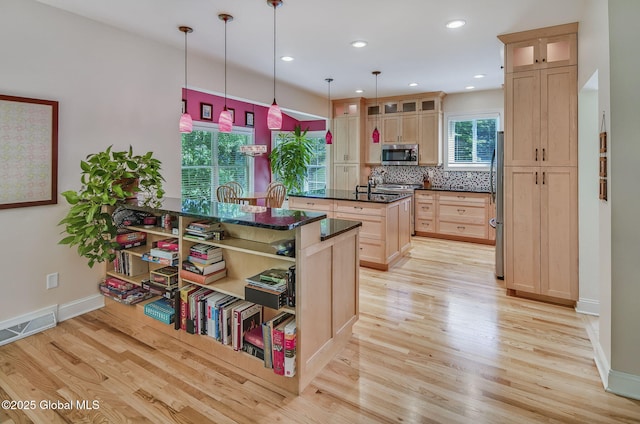 9 Oakline Ct, Niskayuna, NY 12309 - kitchen with appliances with stainless steel finishes, light wood-type flooring, a center island with sink, light brown cabinetry, and baseboards
