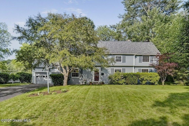 14 Woodridge Rd, Bethlehem, NY 12054 - view of front of house with asphalt driveway, a front yard, and a garage