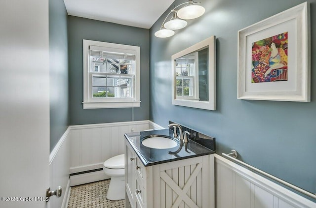 14 Woodridge Rd, Bethlehem, NY 12054 - half bath featuring a baseboard radiator, vanity, and a wainscoted wall
