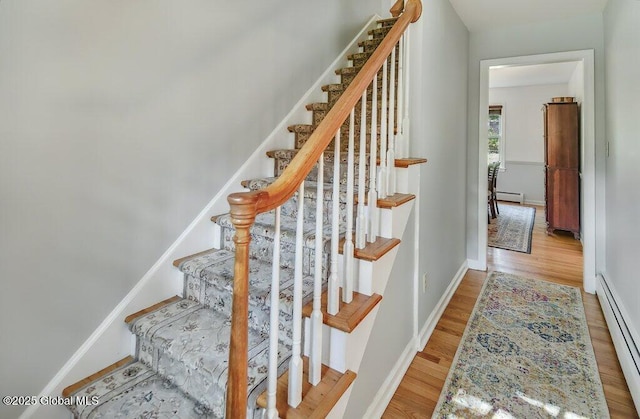 14 Woodridge Rd, Bethlehem, NY 12054 - staircase featuring a baseboard heating unit and wood finished floors