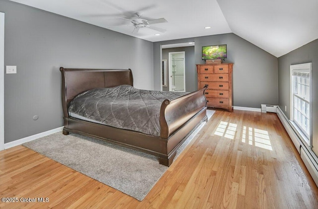 14 Woodridge Rd, Bethlehem, NY 12054 - bedroom featuring vaulted ceiling, wood finished floors, a baseboard heating unit, a ceiling fan, and ensuite bathroom