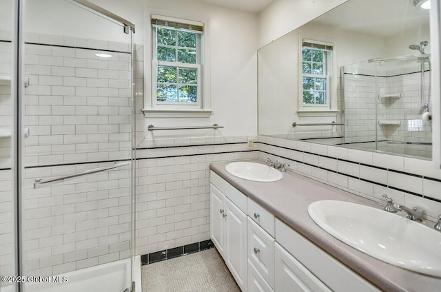 14 Woodridge Rd, Bethlehem, NY 12054 - bathroom featuring tile walls, a stall shower, double vanity, plenty of natural light, and wainscoting
