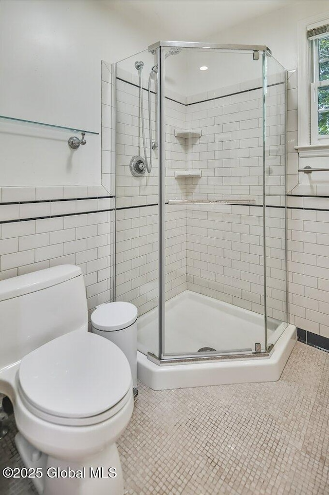 14 Woodridge Rd, Bethlehem, NY 12054 - bathroom featuring a stall shower, tile walls, and tile patterned flooring