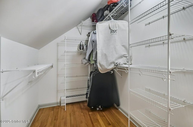 14 Woodridge Rd, Bethlehem, NY 12054 - spacious closet featuring wood finished floors, baseboard heating, and lofted ceiling