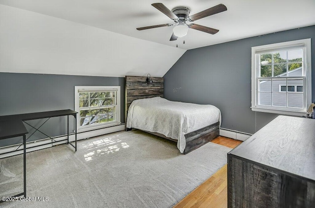 14 Woodridge Rd, Bethlehem, NY 12054 - bedroom with baseboard heating, multiple windows, wood finished floors, lofted ceiling, and ceiling fan