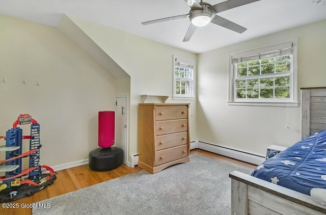 14 Woodridge Rd, Bethlehem, NY 12054 - bedroom with a baseboard heating unit, wood finished floors, ceiling fan, and baseboard heating