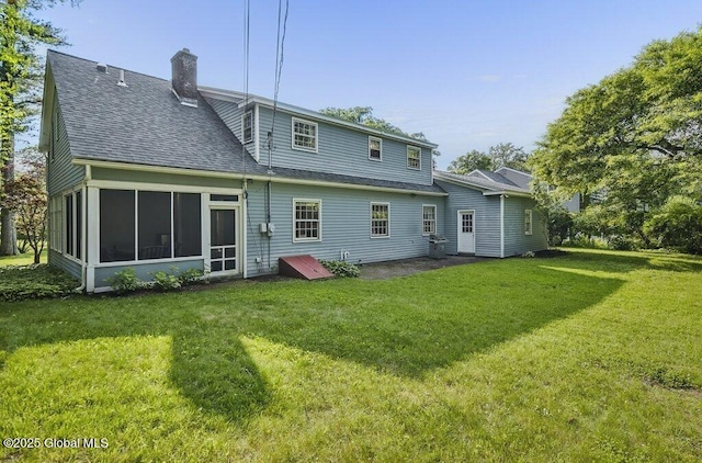 14 Woodridge Rd, Bethlehem, NY 12054 - back of property with roof with shingles, a chimney, a lawn, and a sunroom