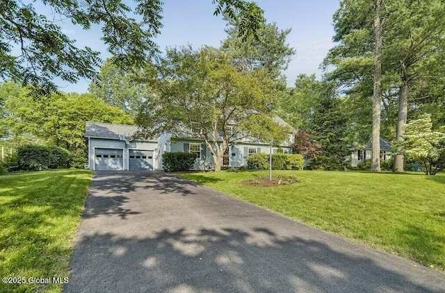 14 Woodridge Rd, Bethlehem, NY 12054 - view of property hidden behind natural elements with driveway, a garage, and a front lawn