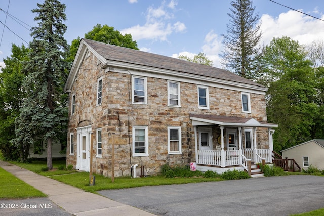 98 George St, Fort Ann, NY 12827 - view of front facade with stone siding, a porch, and a shingled roof