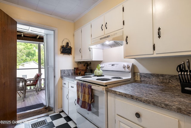 98 George St, Fort Ann, NY 12827 - kitchen with electric stove, under cabinet range hood, dark floors, ornamental molding, and white cabinets