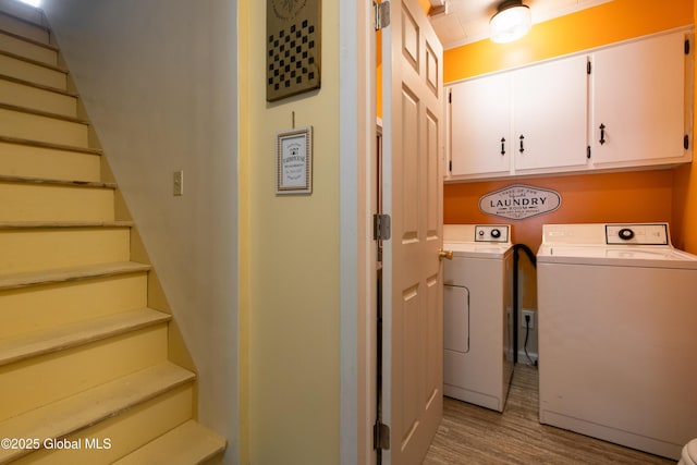 98 George St, Fort Ann, NY 12827 - laundry room featuring washing machine and clothes dryer, cabinet space, and wood finished floors