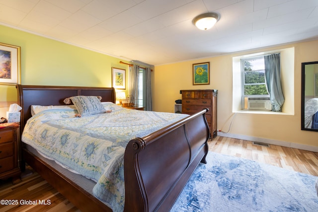 98 George St, Fort Ann, NY 12827 - bedroom featuring wood finished floors, ornamental molding, cooling unit, and baseboards