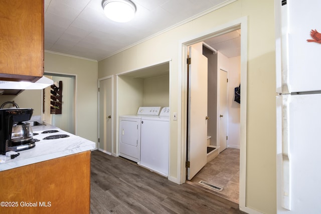 98 George St, Fort Ann, NY 12827 - kitchen featuring freestanding refrigerator, ornamental molding, washer and clothes dryer, light countertops, and wood finished floors