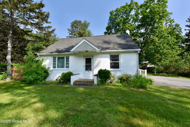 102 Willow St, Guilderland, NY 12084 - single story home featuring stucco siding, a front yard, and a chimney