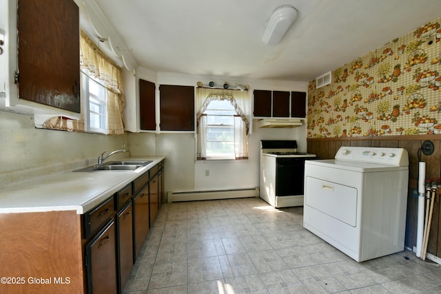 102 Willow St, Guilderland, NY 12084 - kitchen with washer / clothes dryer, white range with gas stovetop, baseboard heating, healthy amount of natural light, and wallpapered walls