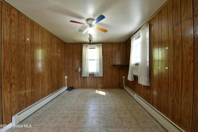 102 Willow St, Guilderland, NY 12084 - empty room featuring a baseboard heating unit, a ceiling fan, wooden walls, and light floors