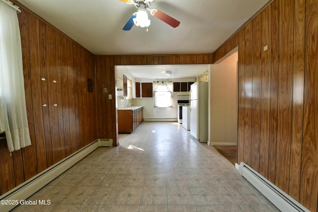102 Willow St, Guilderland, NY 12084 - corridor featuring a baseboard radiator, wood walls, and a sink