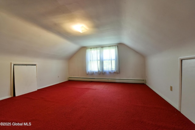 102 Willow St, Guilderland, NY 12084 - additional living space with baseboard heating, vaulted ceiling, baseboards, and carpet floors