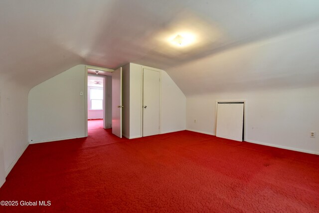 102 Willow St, Guilderland, NY 12084 - additional living space with vaulted ceiling, carpet floors, and baseboards