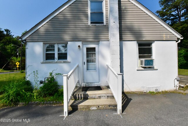 102 Willow St, Guilderland, NY 12084 - view of front facade with stucco siding and cooling unit