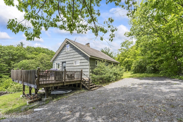 19 Knowles Rd, Rensselaerville, NY 12469 - view of property exterior with a wooden deck, a chimney, and roof with shingles