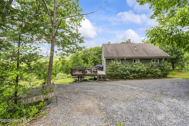 19 Knowles Rd, Rensselaerville, NY 12469 - view of home's exterior with roof with shingles, a wooden deck, driveway, and a chimney