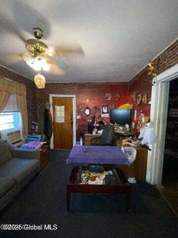 225 Main St, Fort Plain, NY 13339 - living room with carpet flooring, a ceiling fan, brick wall, and cooling unit