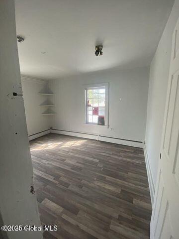225 Main St, Fort Plain, NY 13339 - unfurnished room featuring wood finished floors and a baseboard heating unit