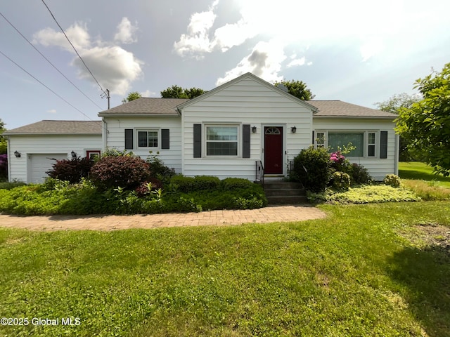 11 Calhoun Rd, Brunswick, NY 12180 - view of front of home with an attached garage, a front lawn, and roof with shingles
