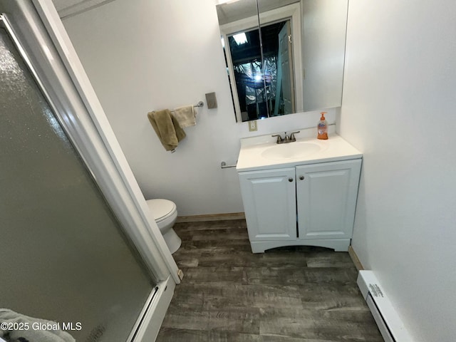 11 Calhoun Rd, Brunswick, NY 12180 - full bath with vanity, wood finished floors, a shower stall, toilet, and a baseboard radiator